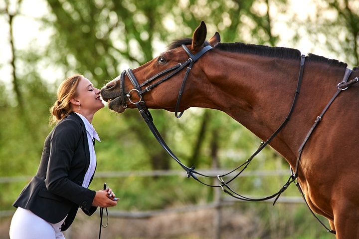 Rider communicating with her horse.